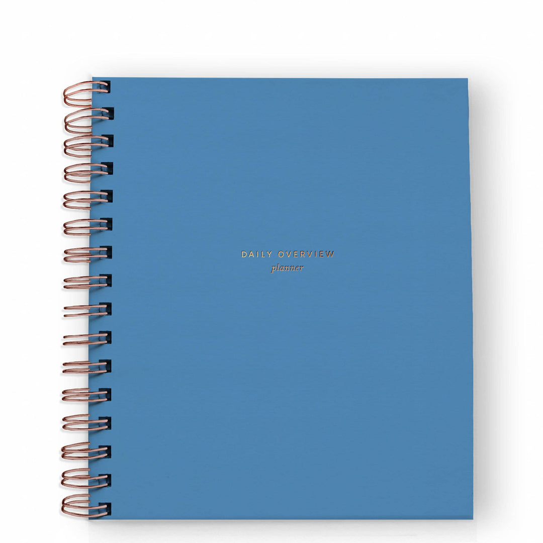 Cover of daily planner in Mediterranean blue with gold spiral binding on the left side.
