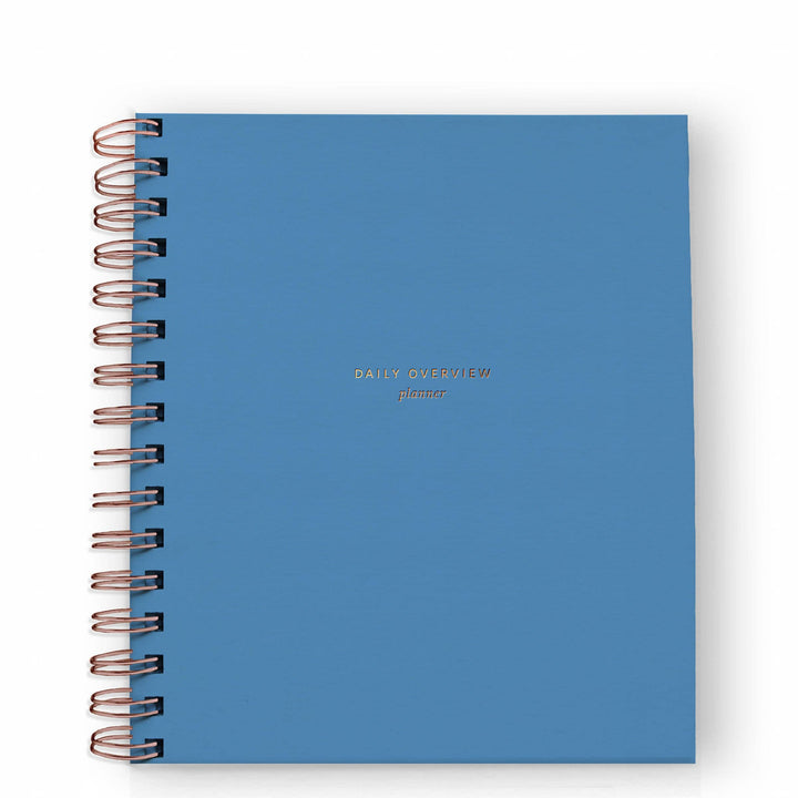 Cover of daily planner in Mediterranean blue with gold spiral binding on the left side.