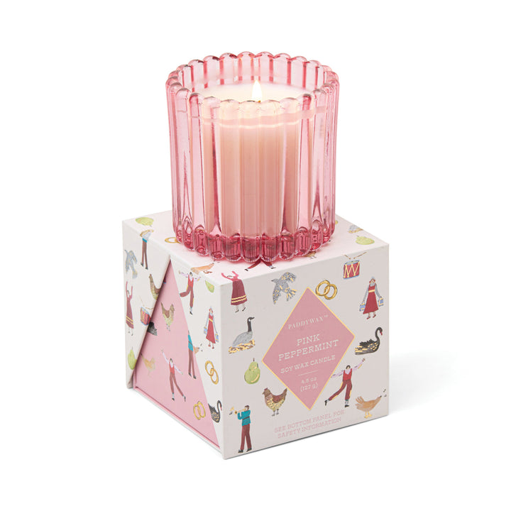 Pink candle in a decorative box with illustrations 