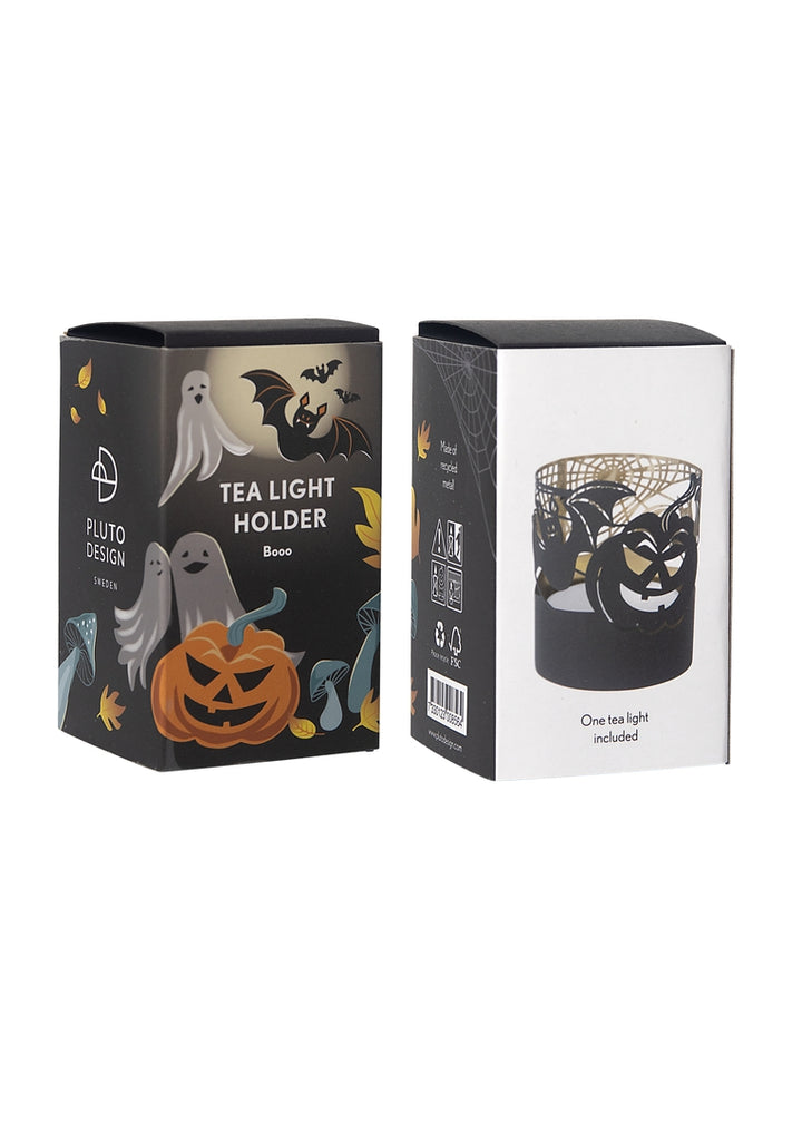 The front and back of the box that contains a mini tealight holder. The front shows Halloween objects - bats, ghosts, pumpkins - on a black background. The back shows the metal tea light out of the box.