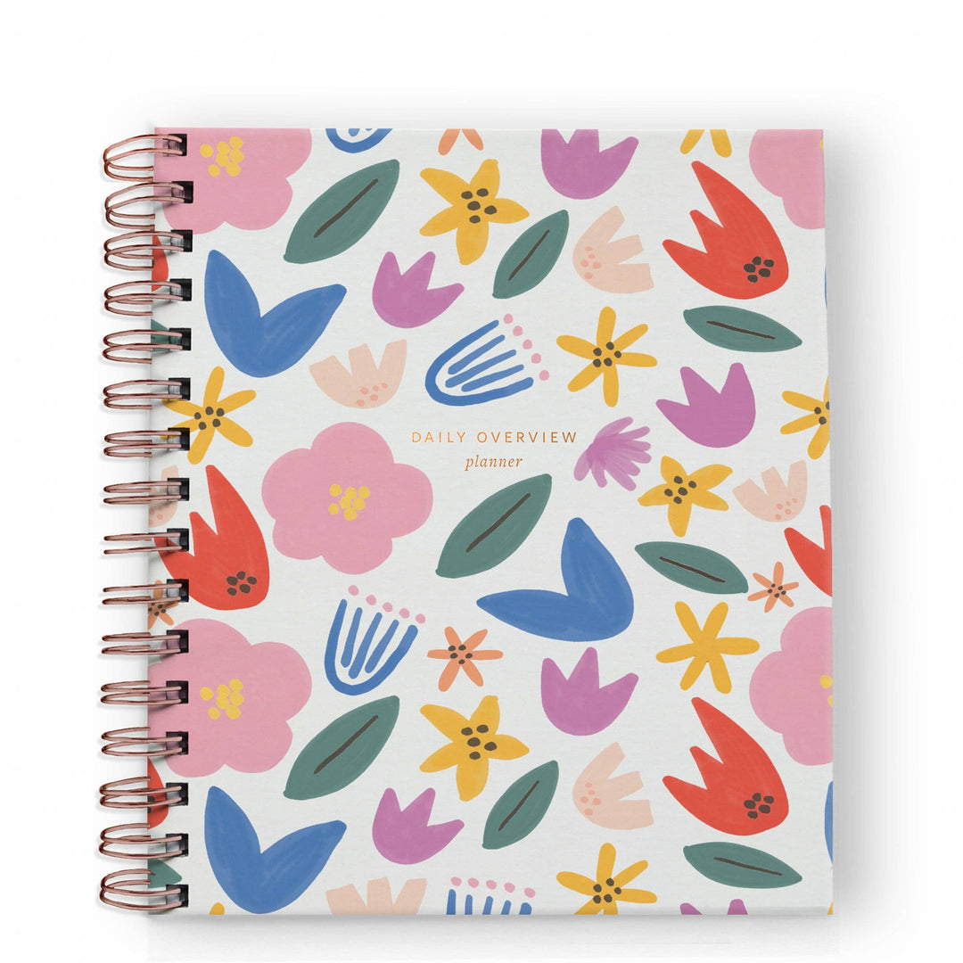 Cover of daily planner with a floral pattern and gold spiral binding on the left side.