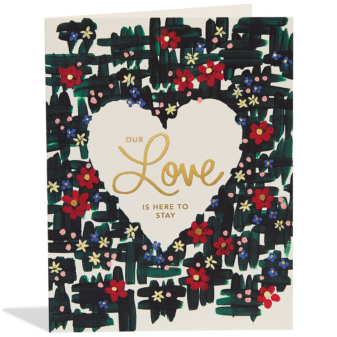 Brightly colored flowers on a background of black strokes. Gold text is in a heart cut out in the center of the card.