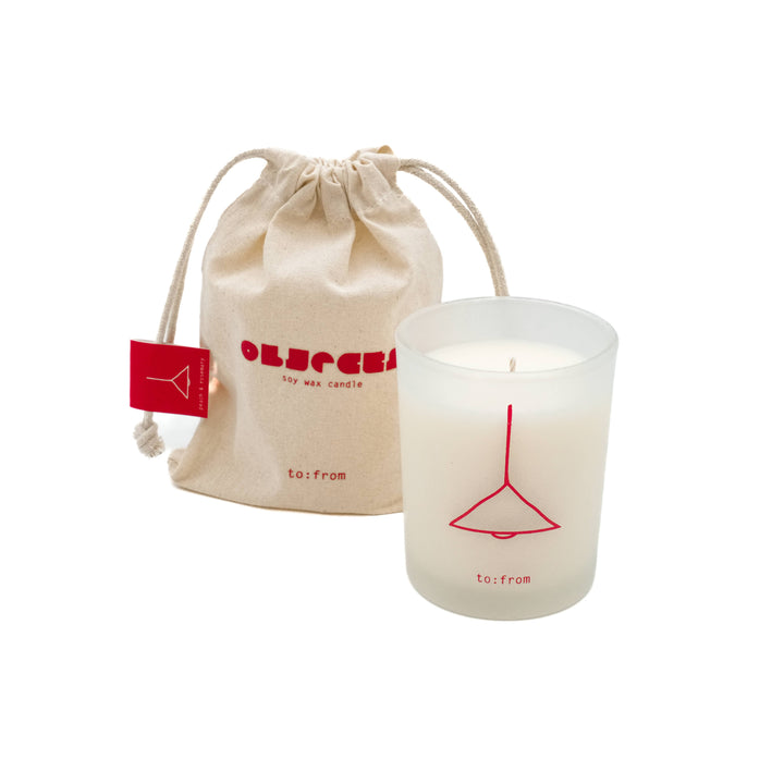 Matte glass printed with the outline of a lamp in red, next to a canvas drawstring carrying bag.