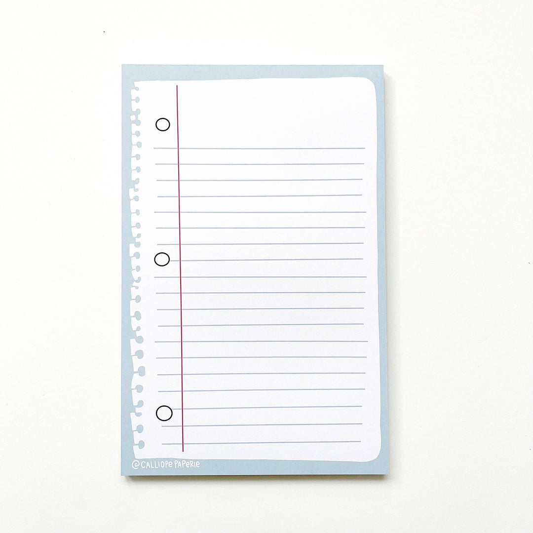 Notepad with illustration of lined 3-ring binder page.