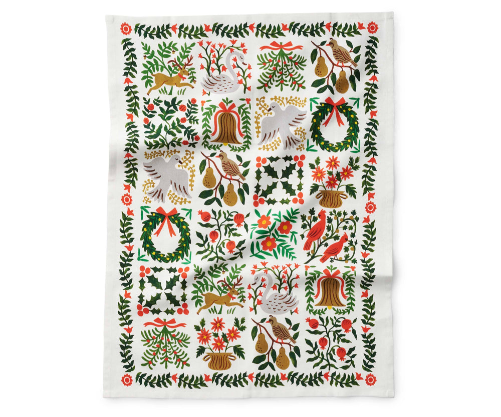 Tea towel with floral and nature-themed illustrations of  a swan, deer, partridge in a pear tree, persimmons and flowers fully open.