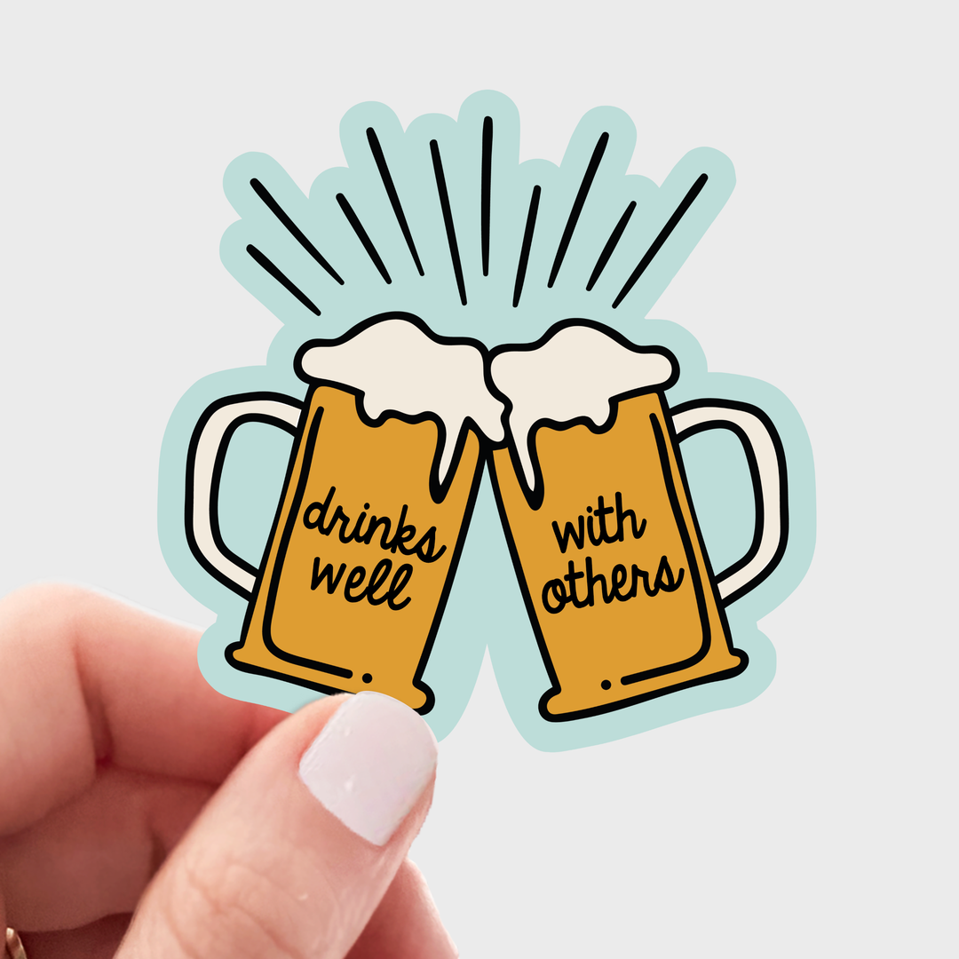Sticker of two beer mugs clinking with 'drinks well with others' text .