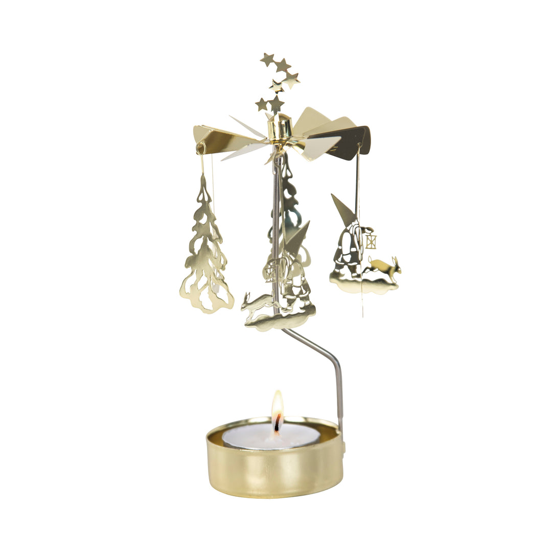 Tea light in a gold holder with vertical arm supporting a carousel of three Santas and three Christmas trees.
