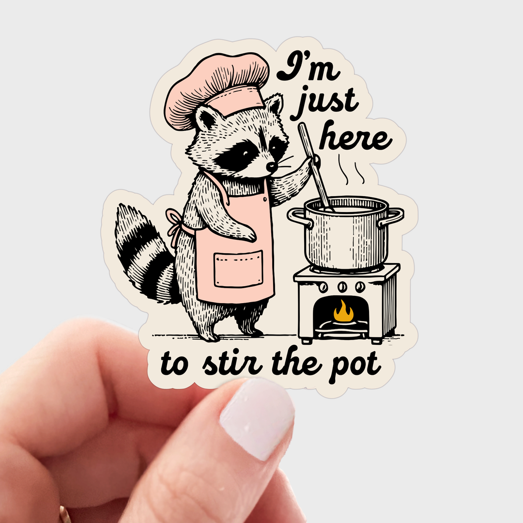 Illustration of a raccoon character wearing a pink apron and chef's hat, stirring a pot on a stove, with the text 'I'm just here to stir the pot' 