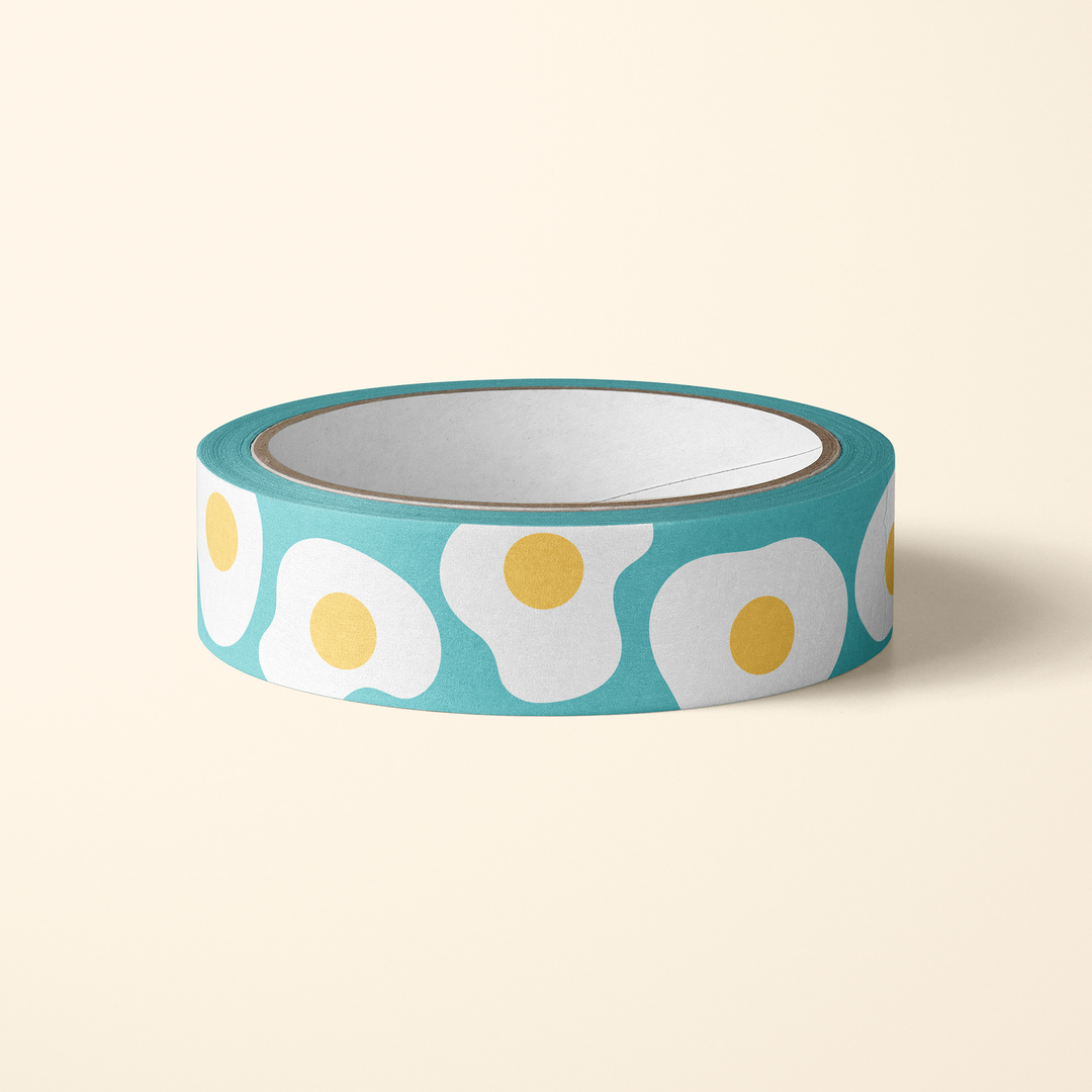 Roll of decorative tape with fried egg design on a beige background