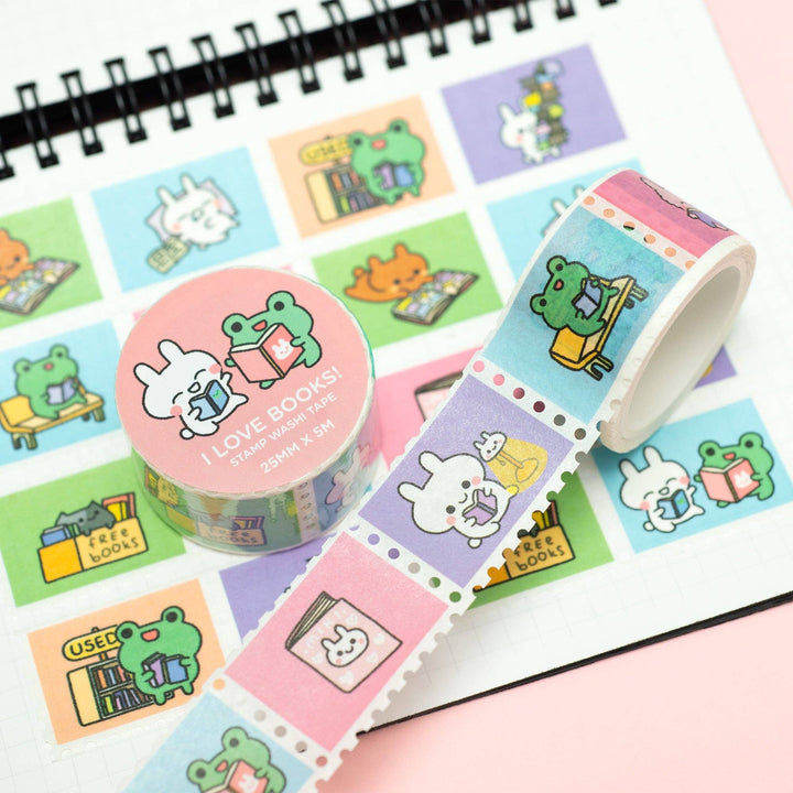 Roll of decorative tape with cartoon character designs on a notebook page.