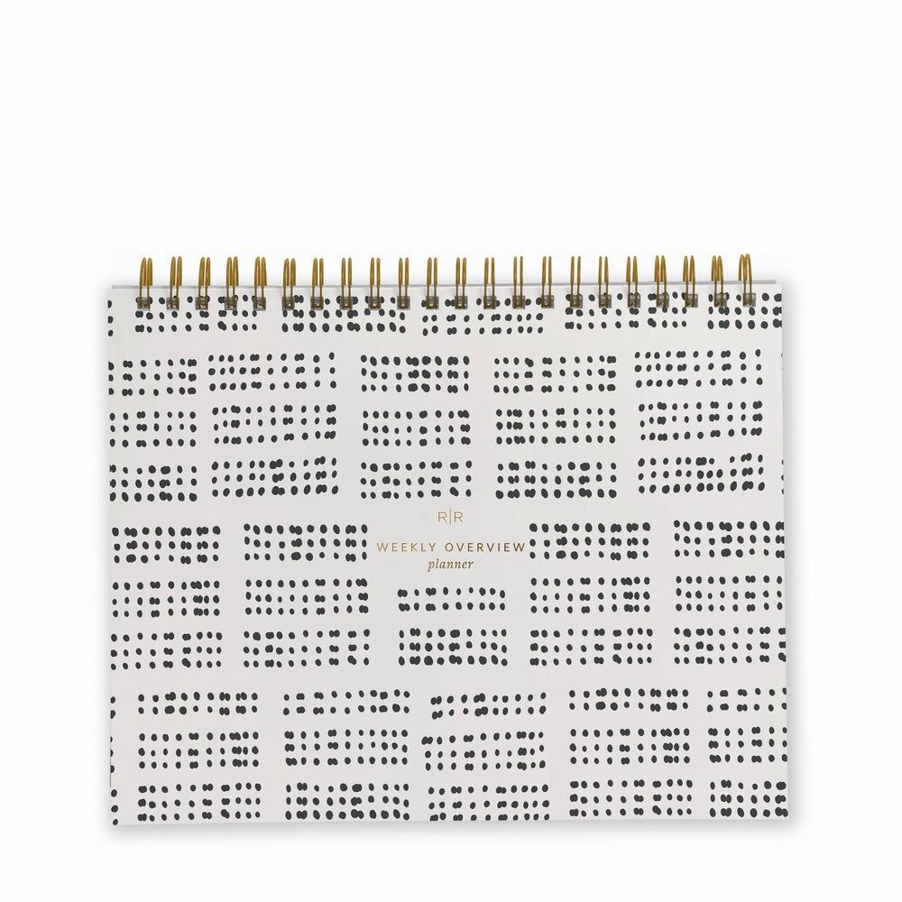Cover of weekly planner with a black dotted grid pattern and gold spiral binding at top.