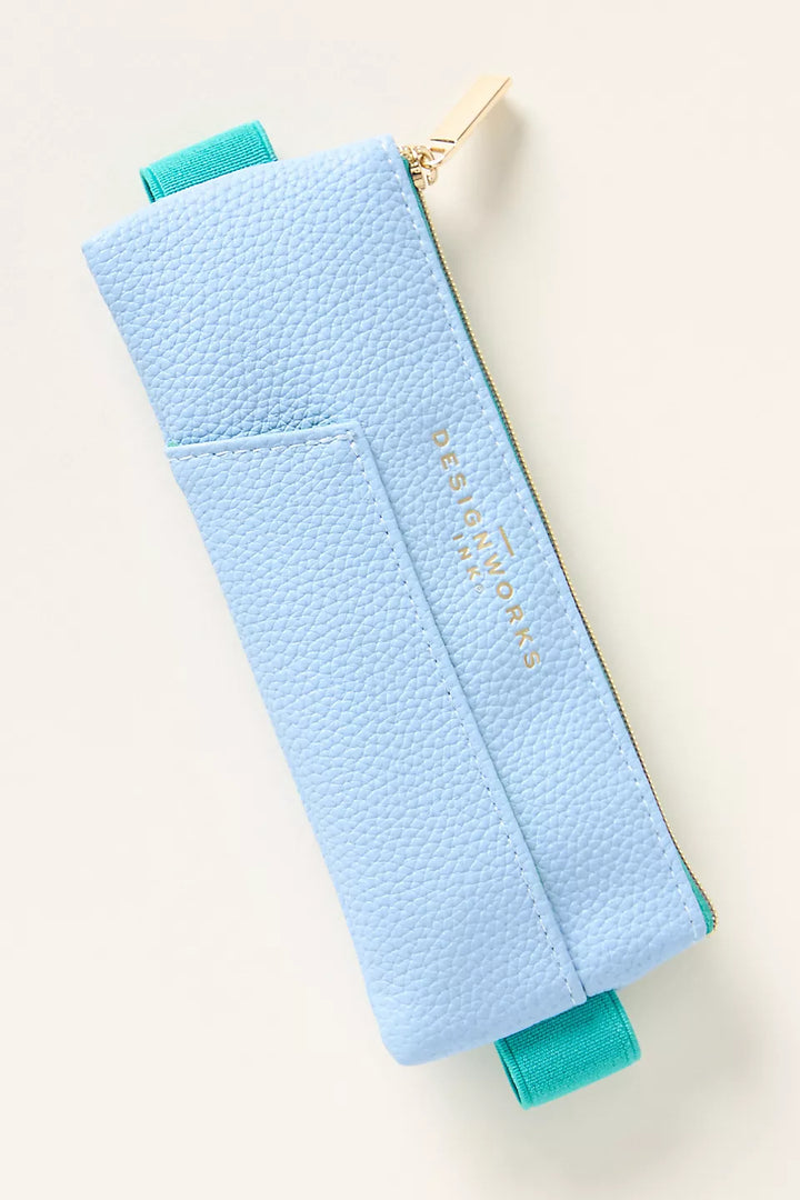 Slim case in blue with gold zipper and green elastic band to slip around a book or journal.