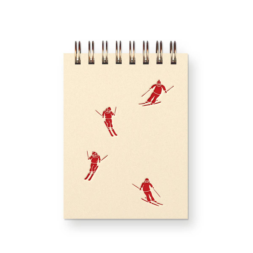 Four red skiing illustrations skilling down the off-white cover 