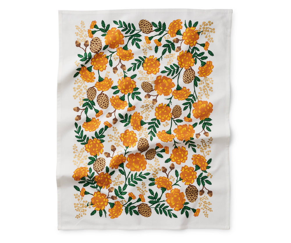 Unfolded tea towel with orange and brown floral pattern.
