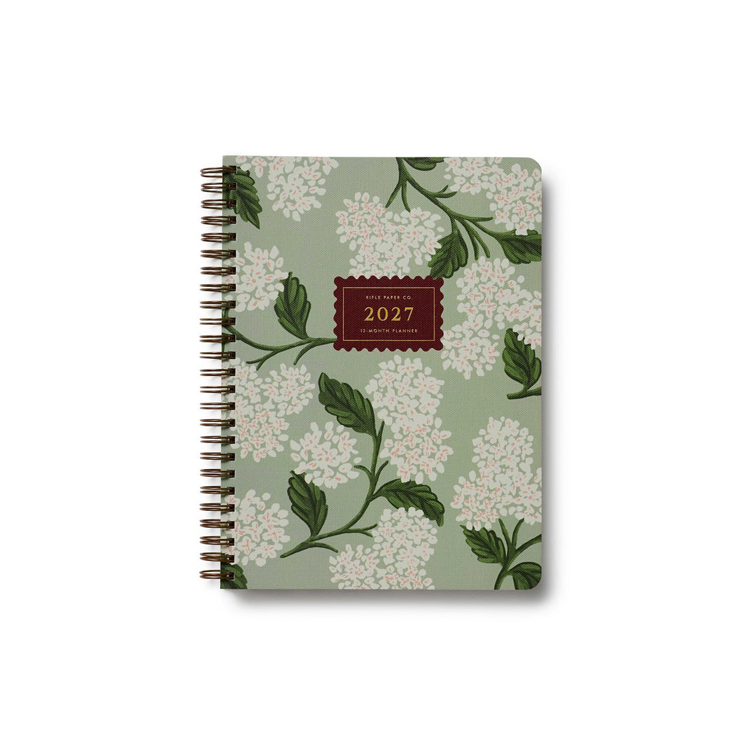 Cover of planner with white hydrangea on a sage green background.