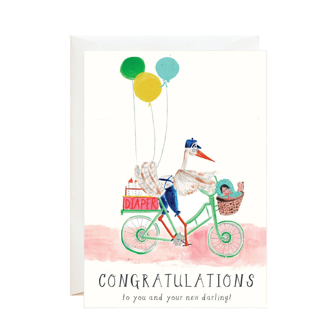 Stork wearing blue pants and hat, riding a green bicycle with a red diaper basket on the back, with three balloons, and a wicker basket with a baby on the handlebars.