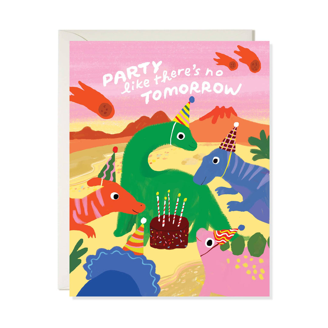A colorful greeting card with a white envelope behind it. The card features a playful illustration of dinosaurs and a birthday cake with the text 'PARTY like there's no TOMORROW' on a pink sky background.