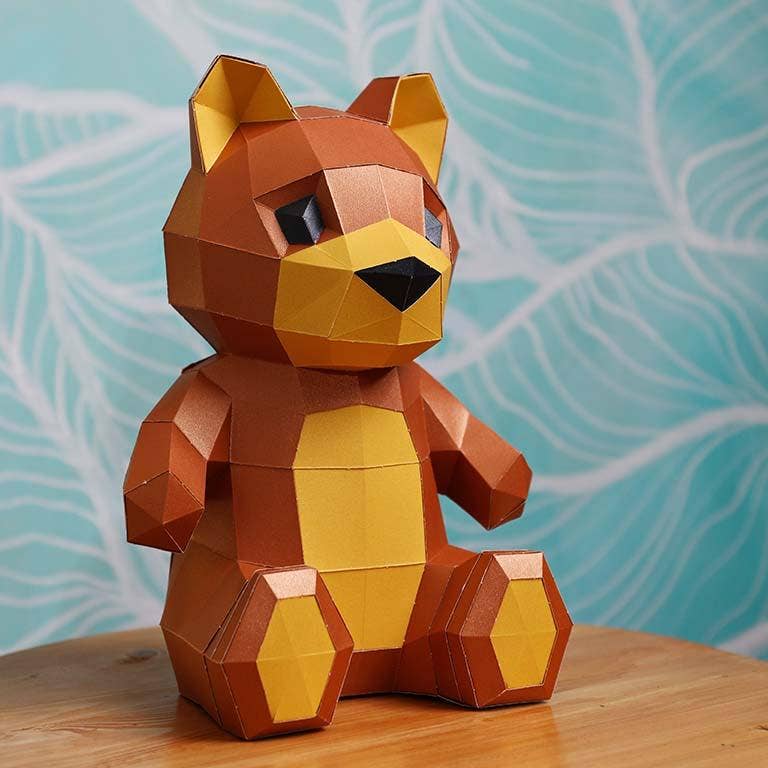 Completed 3D paperboard sitting bear, brown with yellow ears, feet and tummy.