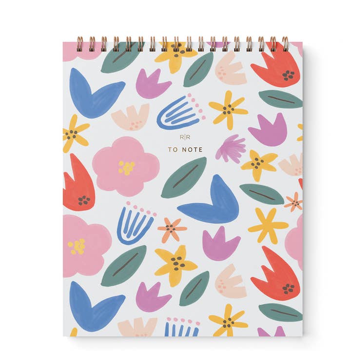 Cover of notebook in a pattern of colorful flowers with gold wire binding at top.