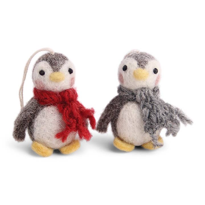 Two felt penguins, one with a red scarf and the other with a gray scarf.