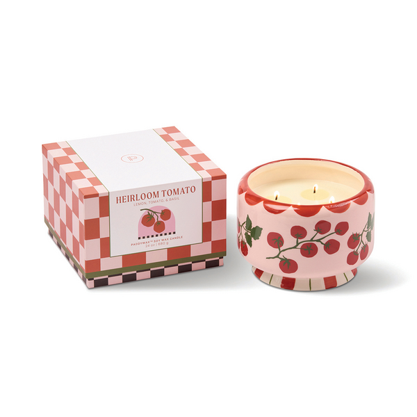Ceramic candle holder with cherry tomato design next to pink and red checked box with 'Heirloom Tomato' label. 