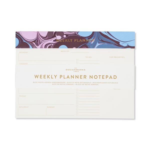 A weekly planner notepad featuring a cream-colored page with gold lettering and lined sections for daily planning, with a purple, blue, and brown marbled header band.