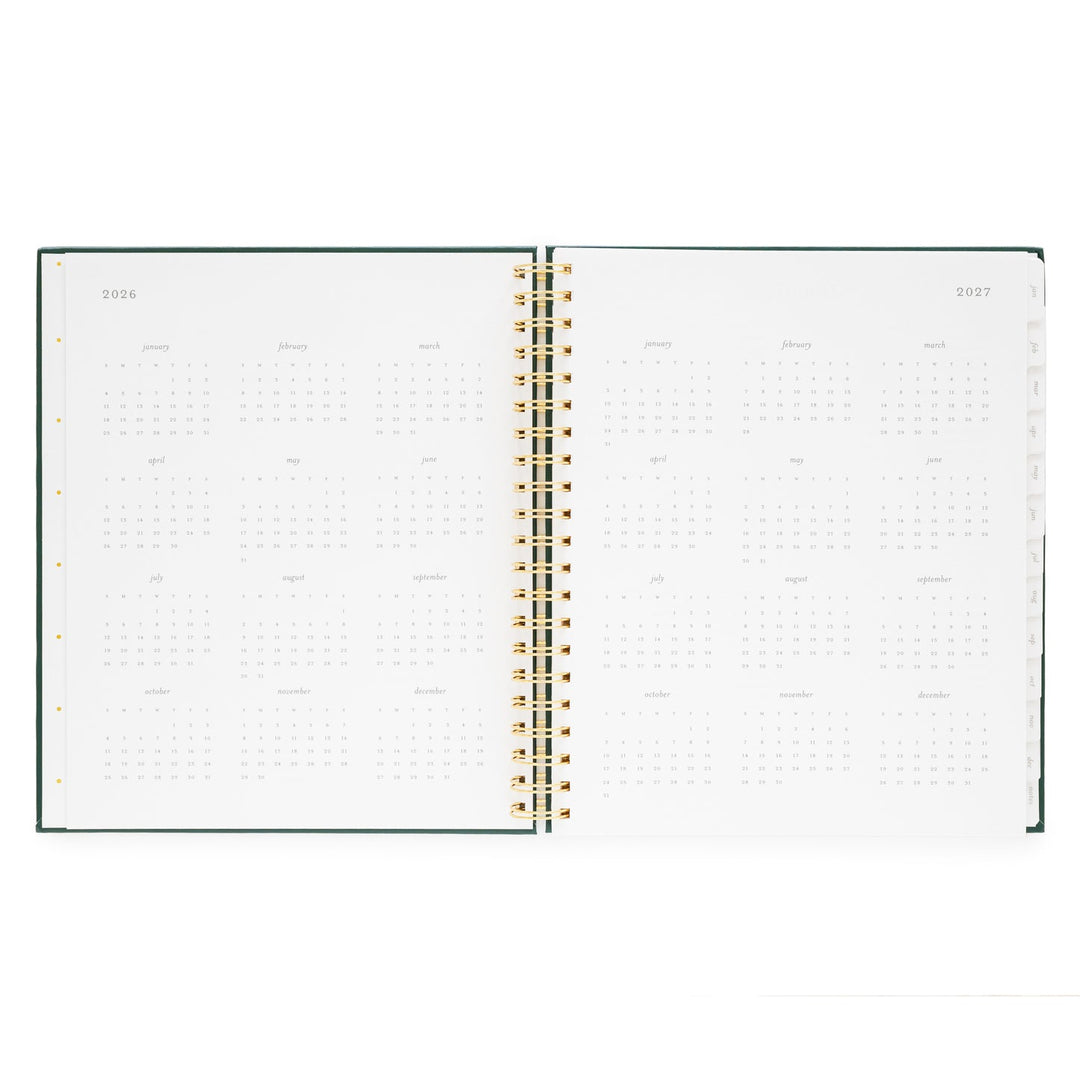 Notebook opened to show a yearly calendar for2026 on the left and 2027 on the right.