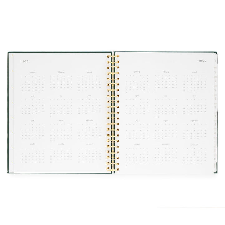 Notebook opened to show a yearly calendar for2026 on the left and 2027 on the right.