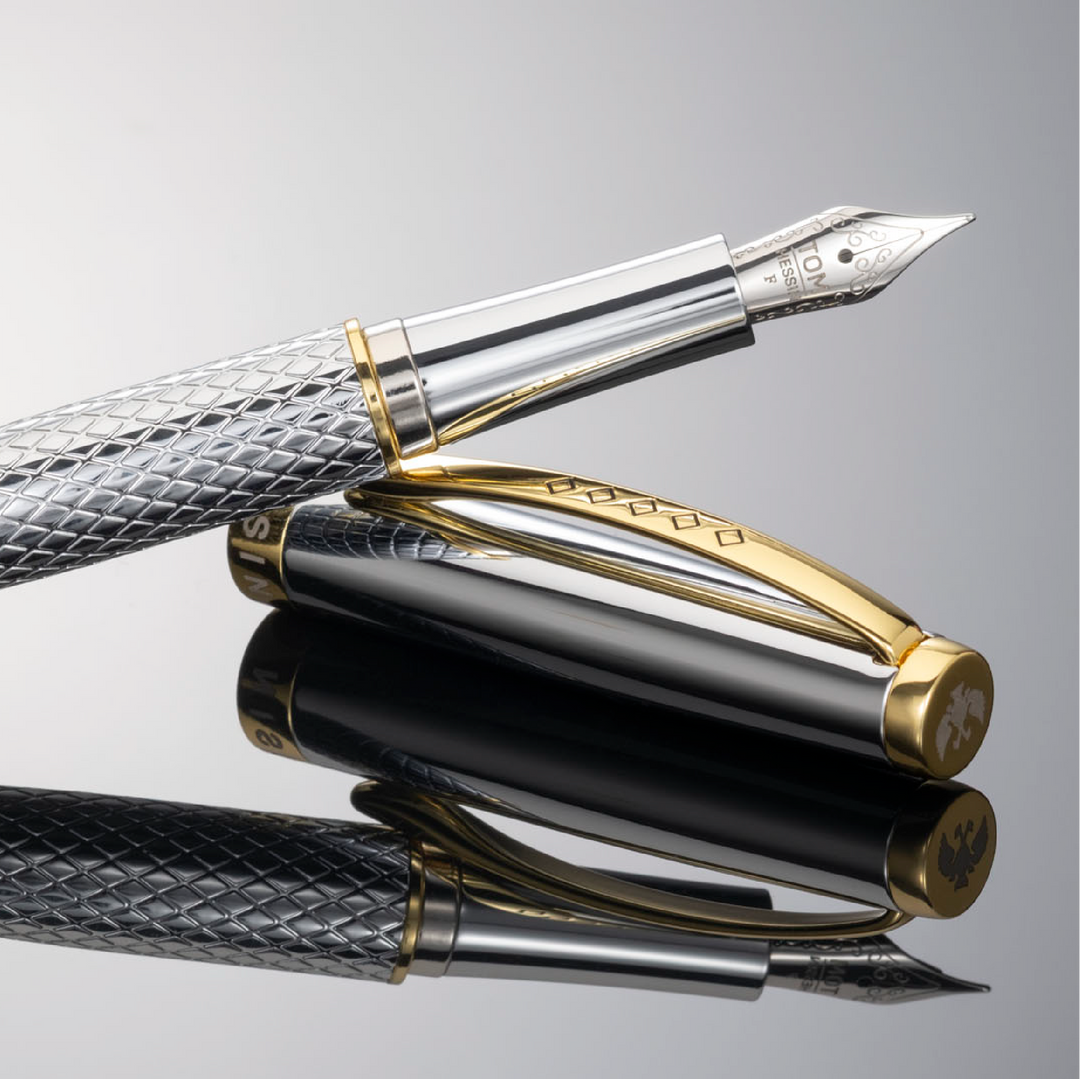 Artful display of the silver fountain pen with gold accents. The pen is resting at an angle on the cap.