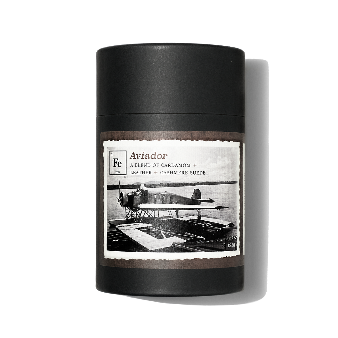 Gift box for Iron Collective candle. Aviador label has image of single-engine old-timey airplane.