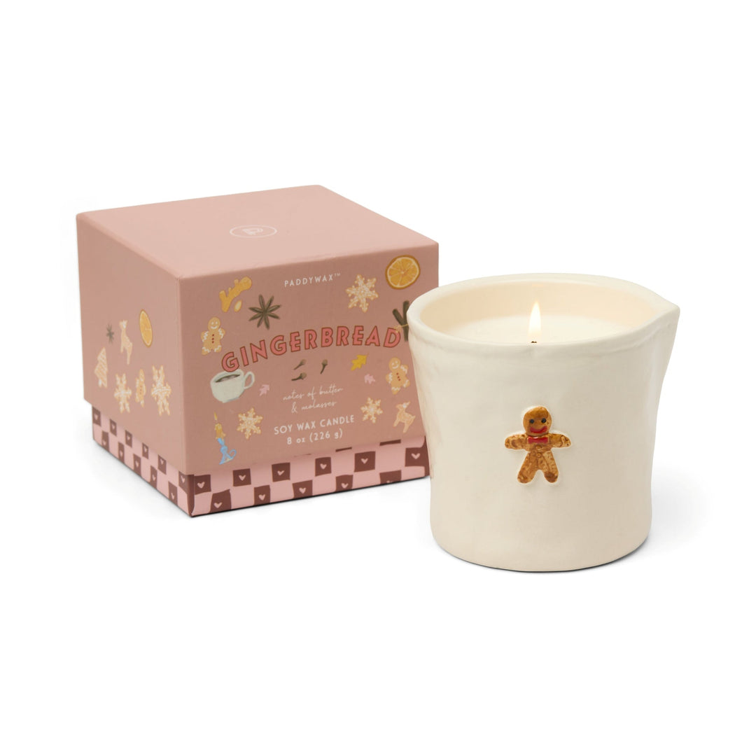 Gingerbread-themed candle with decorative packaging.