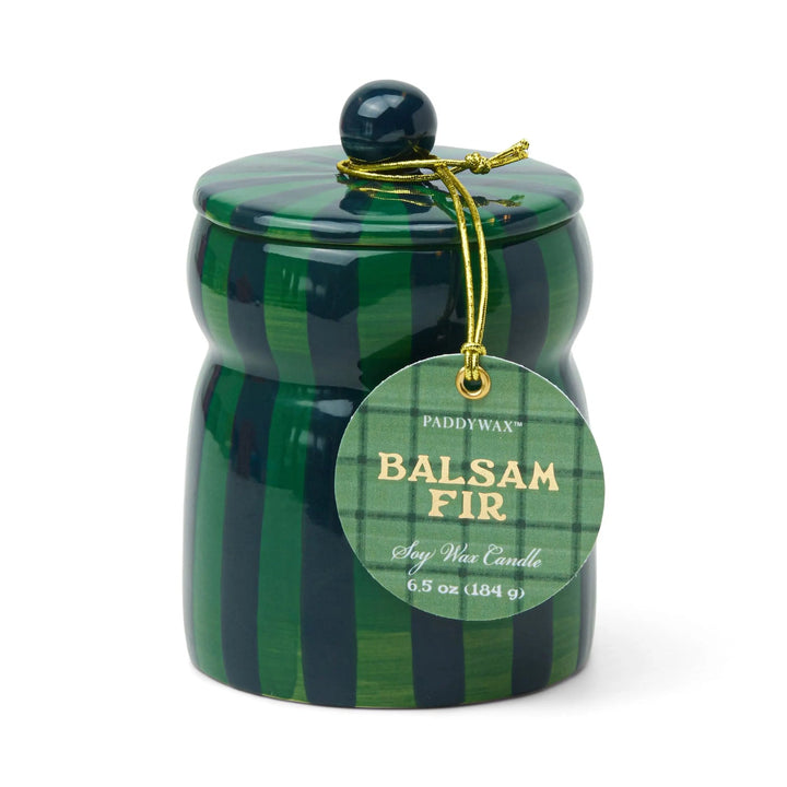 Ceramic candle holder with dark and lighter green vertical stripes, with a round tag on a gold cord.