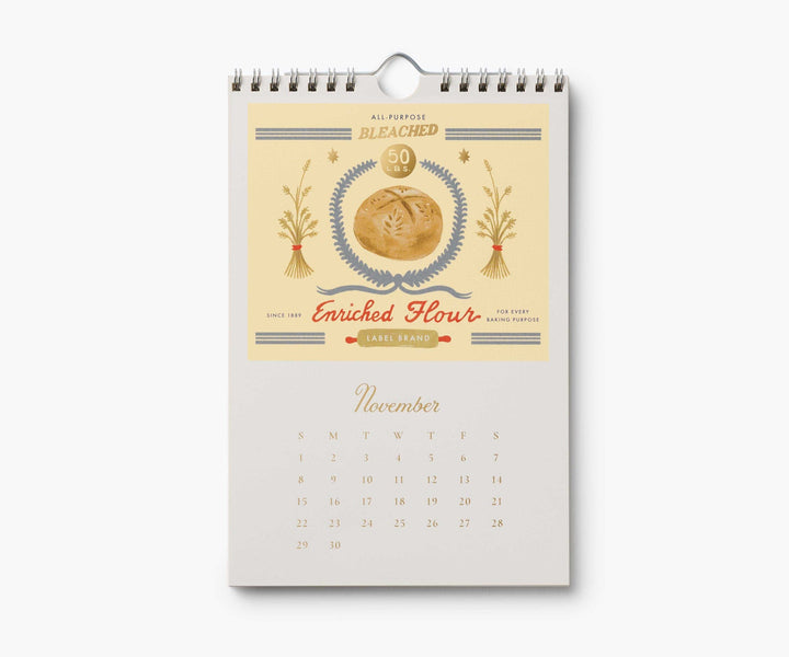 Calendar page for November with illustration for a bag of flour, with a loaf of bread and two wheat stalks, above the calendar for November, 2026.