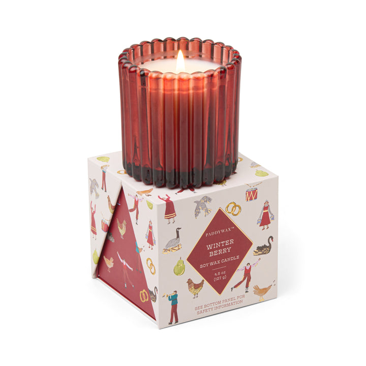Paddywax Winter Berry candle in ribbed glass container, sitting on top of the box it comes in.