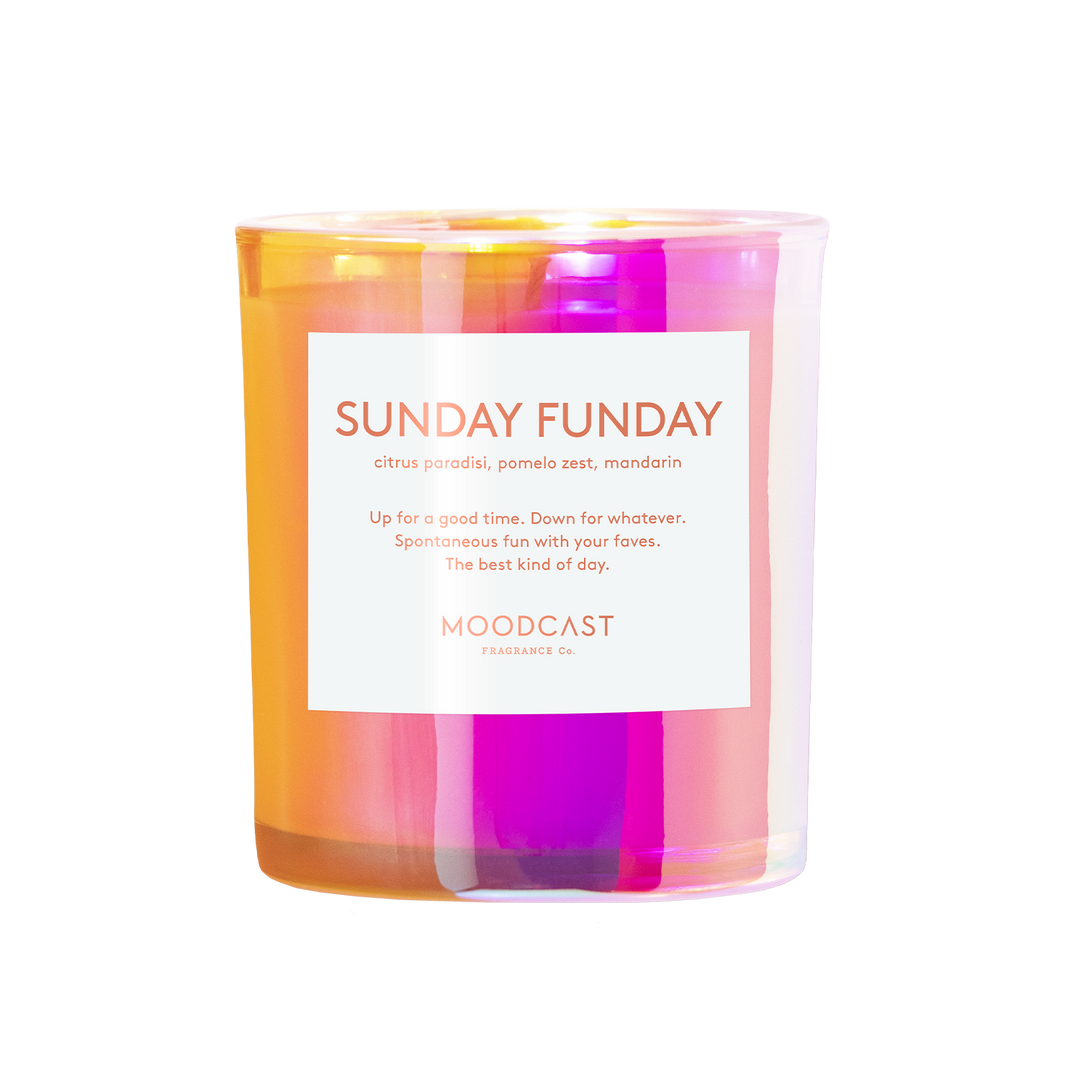 A Moodcast Fragrances 'Sunday Funday' scented candle in a clear glass jar, showing vibrant orange, yellow, and magenta wax layers