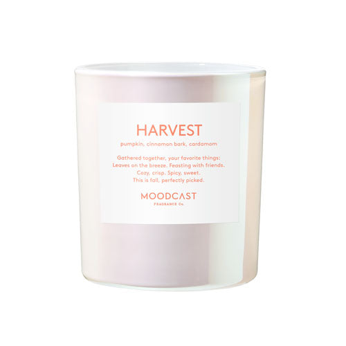 A frosted glass jar candle with a white label reading 'HARVEST' and 'MOODCAST FRAGRANCE CO.'