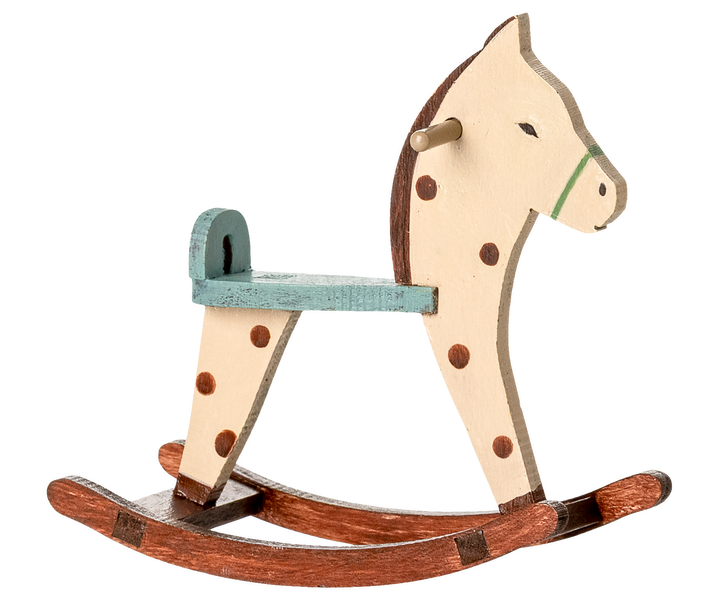 Wooden rocking horse with a white face, brown spots, and a green seat.