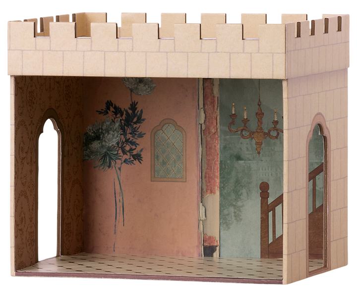 Castle hall with one side open to show the painted interior with pink wall decorated with a plant, a chandelier, and tile floor. There are two openings on either side and a roof with the cutouts that resemble teeth.