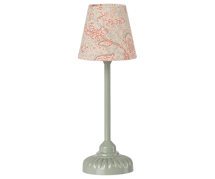 Green floor lamp with a beige lampshade with red flowers. 