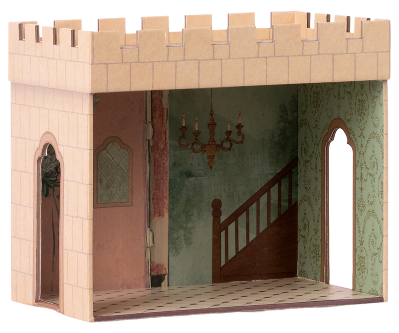 Castle hall with one side open to show the painted interior with green wallpaper, a chandelier, and tile floor. There are two openings on either side and a roof with the cutouts that resemble teeth.