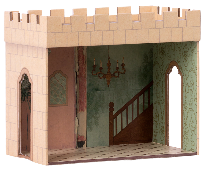 Castle hall with one side open to show the painted interior with green wallpaper, a chandelier, and tile floor. There are two openings on either side and a roof with the cutouts that resemble teeth.