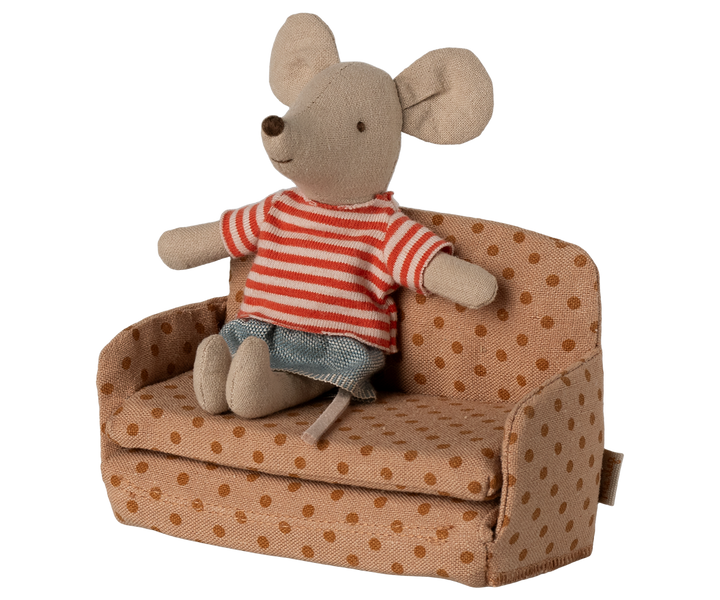 Mouse sitting on sofa.