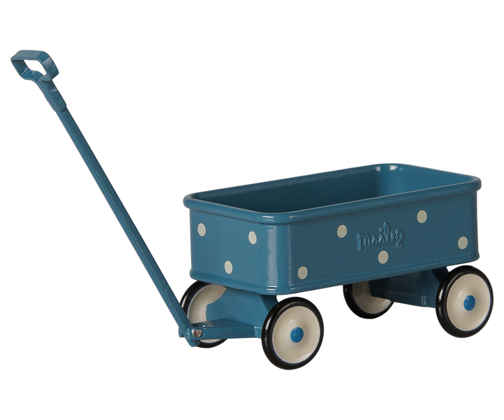 A blue wagon with white polka dots, cream-colored wheels with black rims, and a matching blue handle.