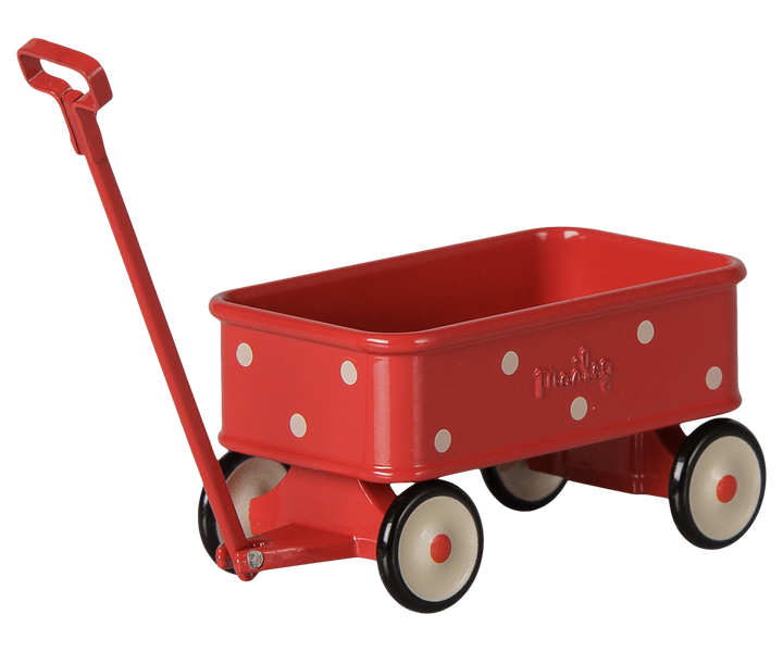 A red metal wagon with white polka dots, cream-colored wheels with black rims, and a red handle.