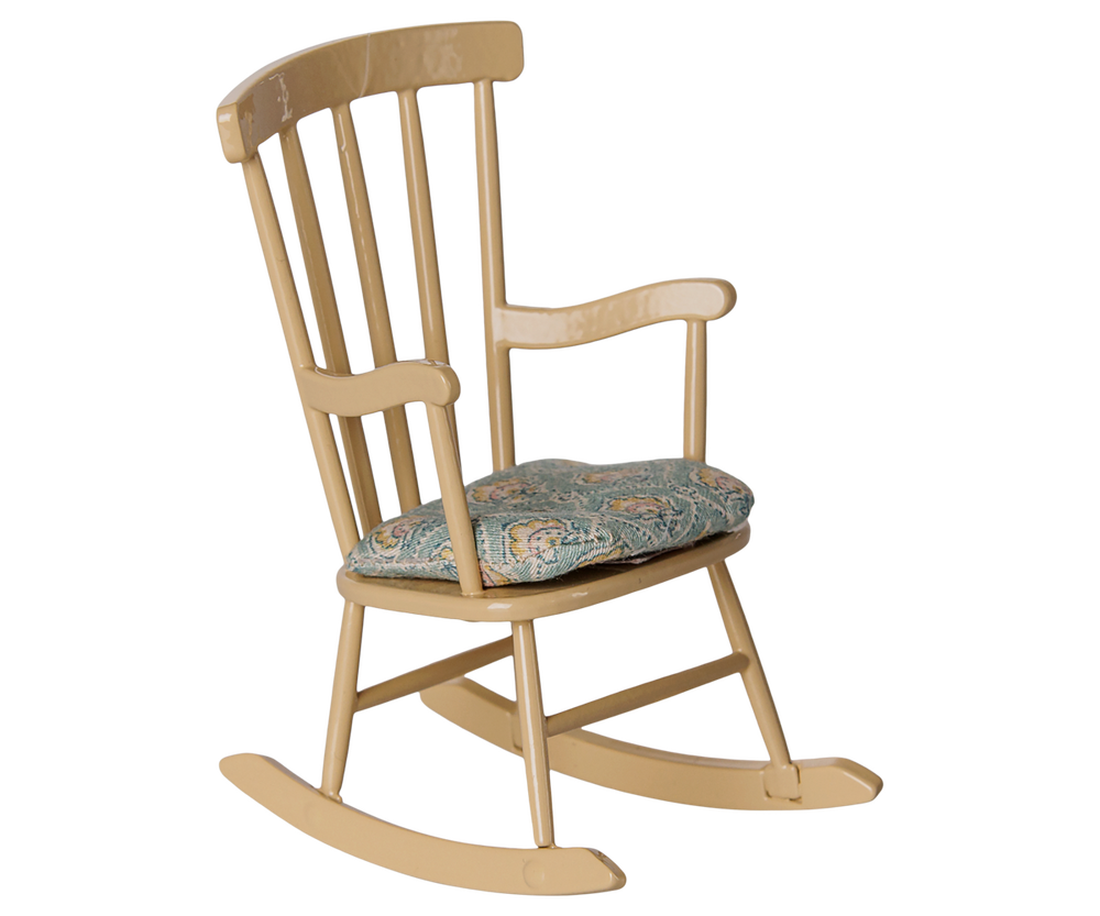 Wheat colored wooden rocking chair in classic style, with blue and off white patterned cushion.