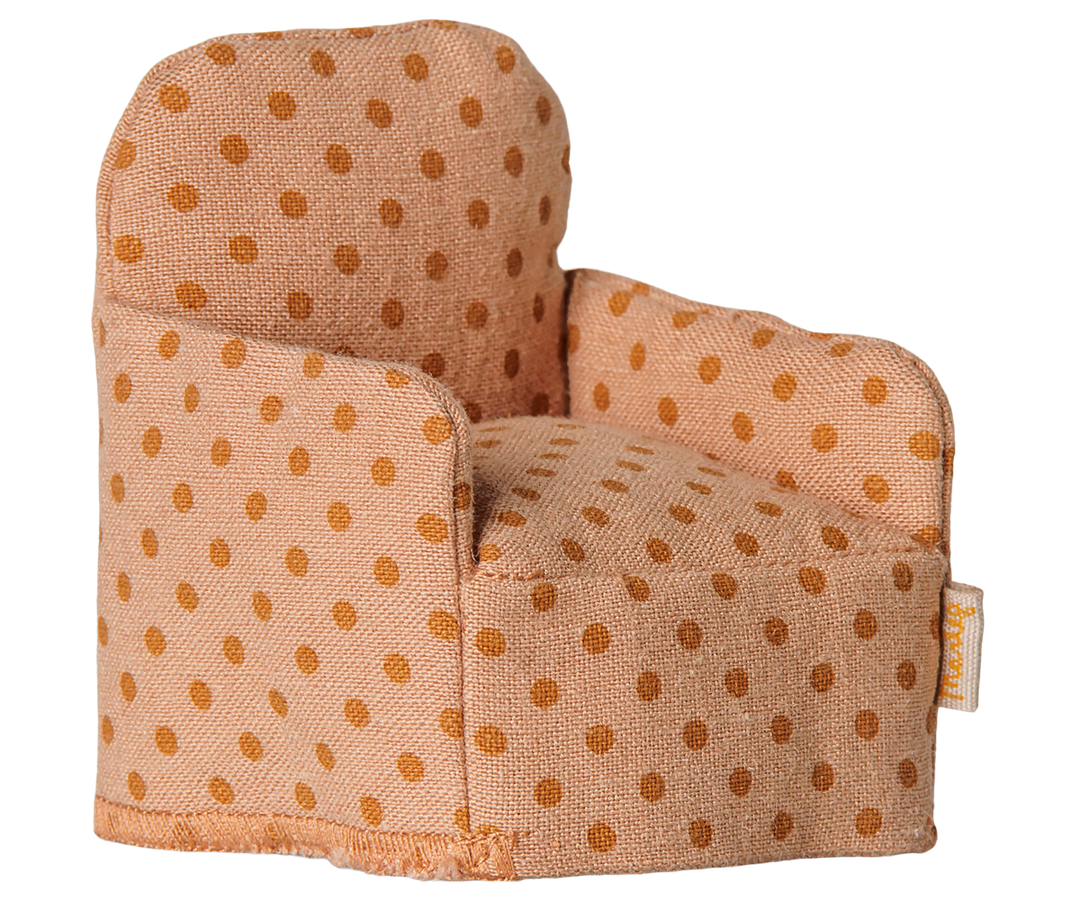 Upholstered armchair with a polka dot  pattern in light and dark orange