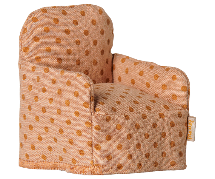 Upholstered armchair with a polka dot  pattern in light and dark orange