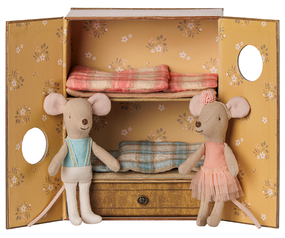 A vintage-style bedroom set that doubles as a dance studio, featuring a  floral yellow doors,  a pull-out drawer, two mice dolls dressed in ballet clothes, and matching plaid bedding inside.