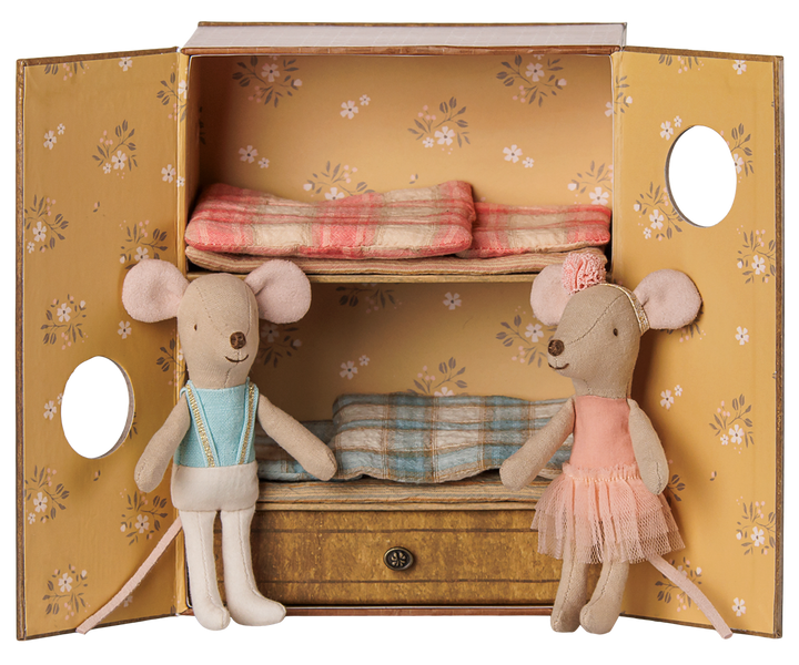 A vintage-style bedroom set that doubles as a dance studio, featuring a  floral yellow doors,  a pull-out drawer, two mice dolls dressed in ballet clothes, and matching plaid bedding inside.