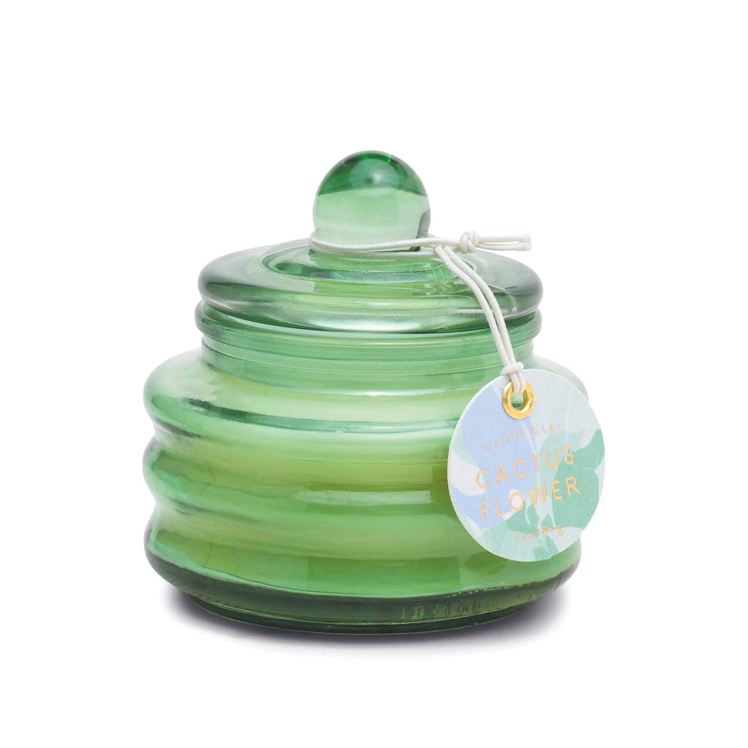 Translucent lidded glass jar with stylish round tag on a string in green.